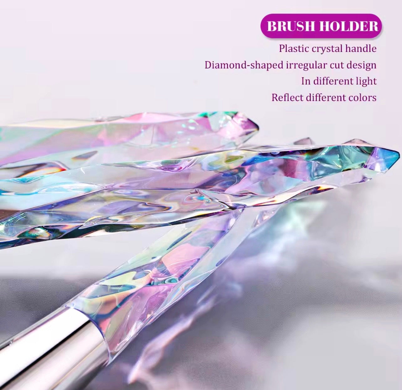10-piece vegan makeup brush set with iridescent, crystal-style handles, contained in a clear, holographic carrying case.