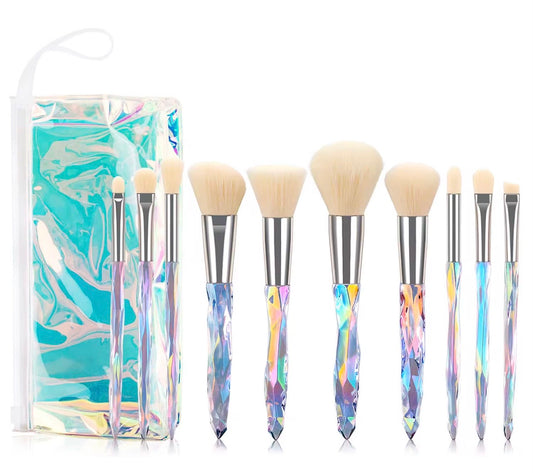 10-piece vegan makeup brush set with iridescent, crystal-style handles, contained in a clear, holographic carrying case.