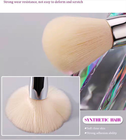 10-piece vegan makeup brush set with iridescent, crystal-style handles, contained in a clear, holographic carrying case.